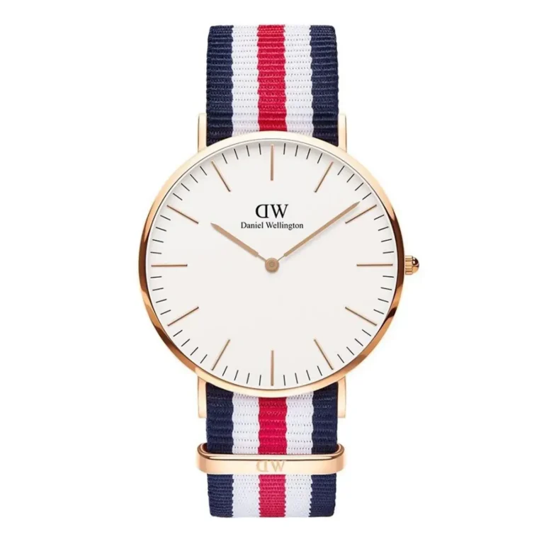 A stylish Daniel Wellington watch featuring a white face, gold hands, and a navy, red, and white striped fabric strap.