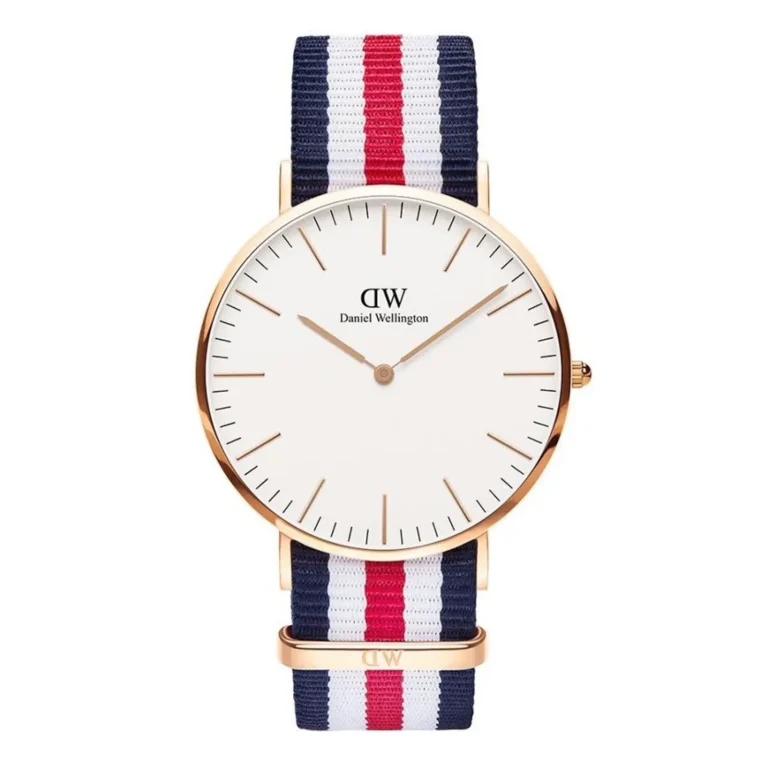 A stylish Daniel Wellington watch featuring a white face, gold hands, and a navy, red, and white striped fabric strap.