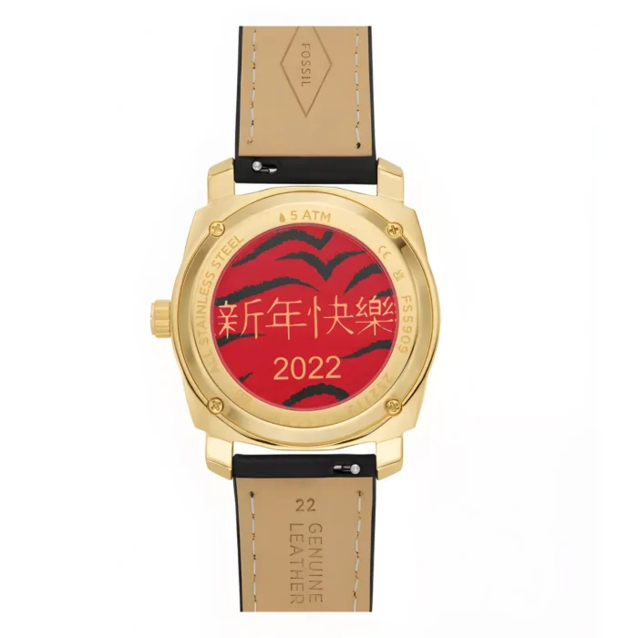 FOSSIL FS5909-4 Gold-tone watch back featuring a red design with "新年快乐" (Happy New Year) and "2022", leather strap labeled "Genuine Leather".