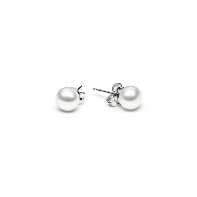 A pair of elegant pearl stud earrings set in silver, showcasing lustrous, round white pearls on a clean white background