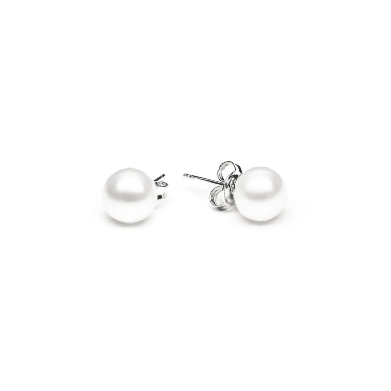A pair of elegant white pearl stud earrings with silver posts, resting on a clean white background