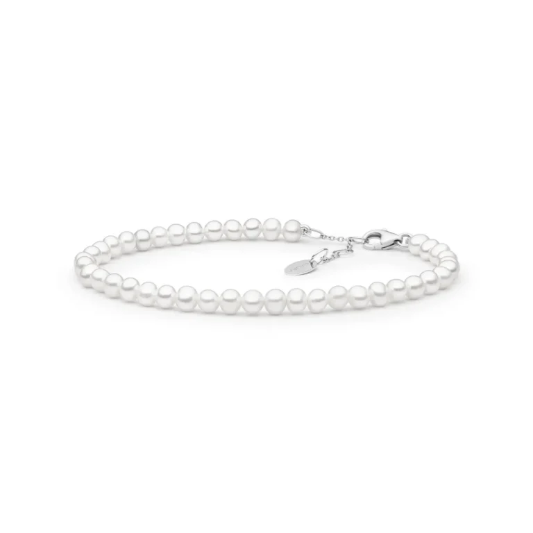 Elegant white pearl bracelet with a silver clasp and adjustable chain, showcasing a classic and timeless design.