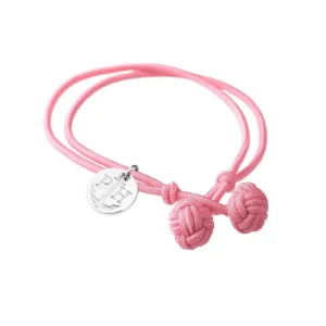 A pink woven bracelet with two knot charms and a silver pendant featuring an anchor and initials "PH."