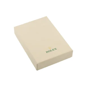 Closed beige Rolex watch box featuring the brand's green logo and gold crown emblem on the top