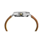 Side view of a sleek silver watch with a gold crown and a rich brown leather strap, showcasing its modern design.