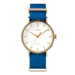 A stylish Timex watch featuring a gold-tone case, white dial, and a vibrant blue silicone strap with a decorative accent.