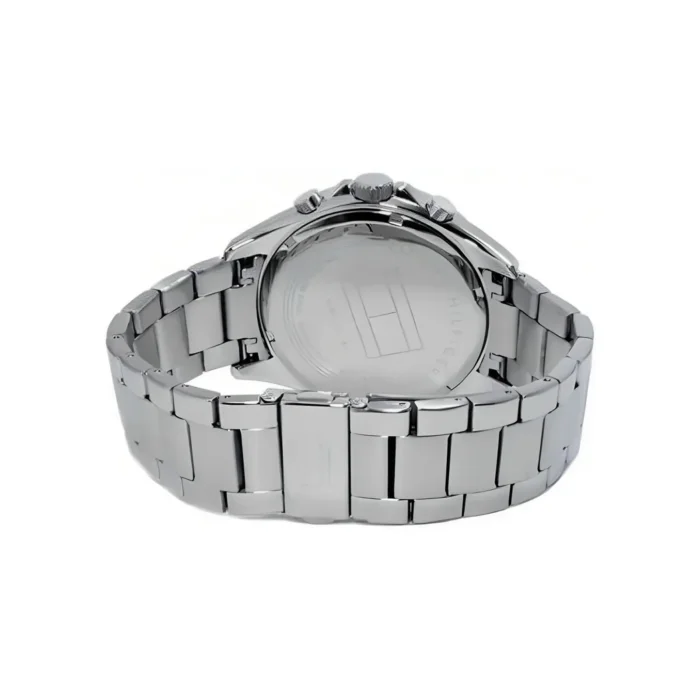 TOMMY HILFIGER 1791122-2 Nerūdijančio plieno chronografo laikrodžio galinė pusė, demonstruojanti poliruotą apyrankę ir permatomą korpuso galinę dalį su prekės ženklo detale.