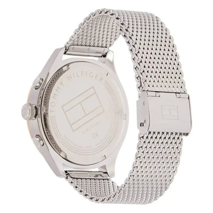 TOMMY HILFIGER 1791466-2 Hõbedane Tommy Hilfiger käekell võrkketiga; tagaküljel on brändi logo ja teave roostevabast terasest materjali kohta.