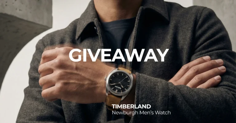 Man wearing a dark jacket showcases a Timberland Newburgh Men’s Watch with a tan band. The text "Giveaway" is boldly displayed. The image conveys a promotional and stylish tone.