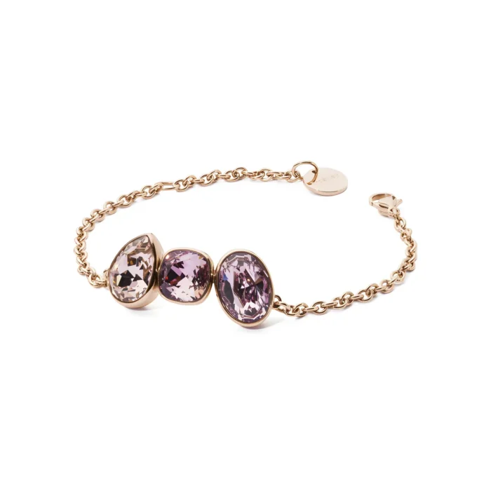 A delicate gold chain bracelet featuring three oval, purple gemstones, elegantly showcasing their sparkling facets.