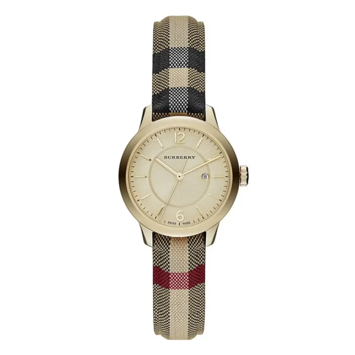 A gold Burberry watch with a minimalist dial and date feature, featuring a plaid fabric strap in beige, black, and red.