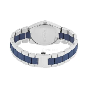 Close-up of a Calvin Klein watch featuring a silver case and a blue rubber strap, showcasing its sleek design and branding.