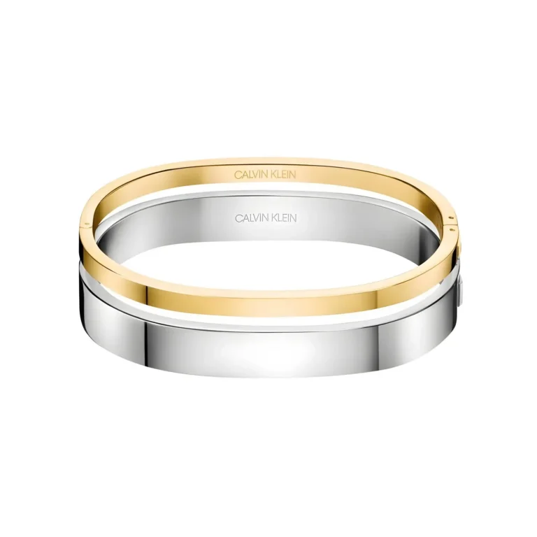 Two sleek bangles, one gold and one silver, featuring the Calvin Klein logo, stacked elegantly on a white background.