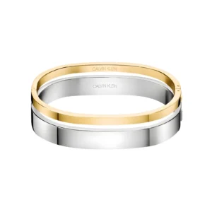 Two sleek bangles, one gold and one silver, featuring the Calvin Klein logo, stacked elegantly on a white background.