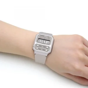 A close-up of a digital Casio watch, displaying 11:57:10, worn on a person's wrist, against a plain white background.