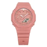 Close-up of a pink Casio G-Shock watch featuring a digital display, analog hands, and a sturdy rubber strap.