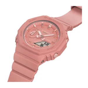 Close-up of a pink Casio G-Shock watch featuring an analog-digital display, durable rubber strap, and multiple function buttons.