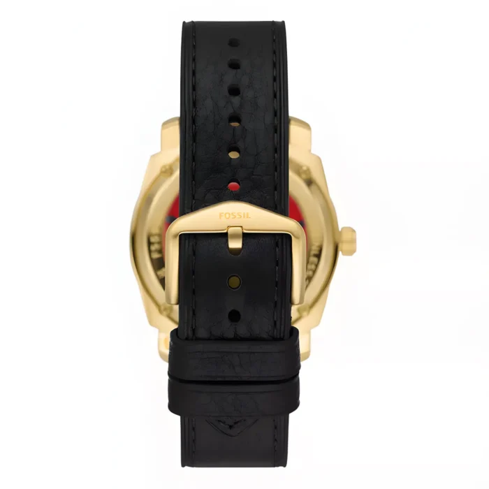 Black leather watch strap with a gold buckle and Fossil branding, showcasing the back of a stylish timepiece.