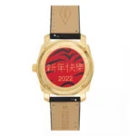 Gold-tone watch back featuring a red design with "新年快乐" (Happy New Year) and "2022", leather strap labeled "Genuine Leather".