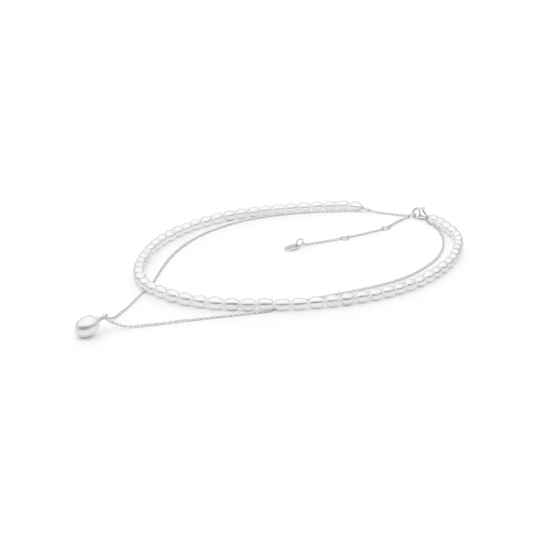 Elegant layered necklace featuring white pearls, with a delicate silver chain and a single pearl drop pendant.