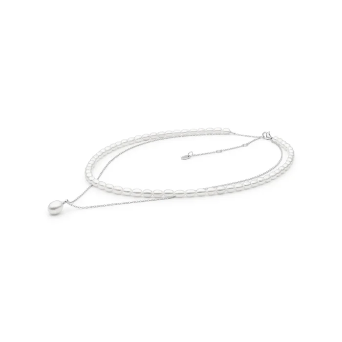Elegant layered necklace featuring white pearls, with a delicate silver chain and a single pearl drop pendant.