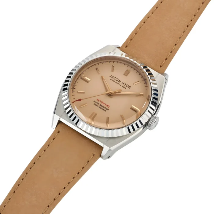 A stylish Jason Hyde watch featuring a beige dial, silver case, and tan leather strap, labeled "SEVENTIES" with water-resistant details.