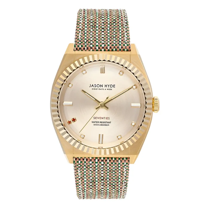 Gold-tone Jason Hyde watch with a textured woven strap, featuring a metallic dial and diamond markers, labeled "Seventies."