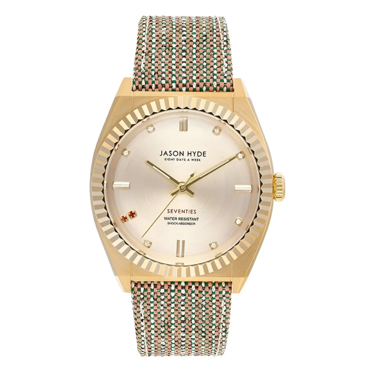 Gold-tone Jason Hyde watch with a textured woven strap, featuring a metallic dial and diamond markers, labeled "Seventies."