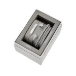 Elegant Fossil jewelry set in a stylish gray box, featuring silver bracelets with sparkling accents and a sleek design.