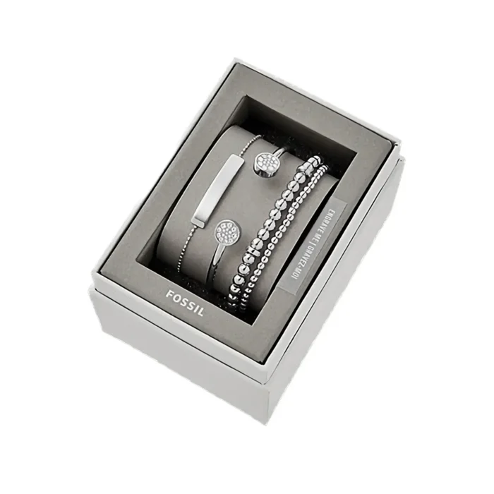 Elegant Fossil jewelry set in a stylish gray box, featuring silver bracelets with sparkling accents and a sleek design.