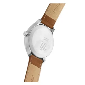 Close-up view of a Mondaine watch back showcasing a stainless steel case and a tan leather strap with engraved details.