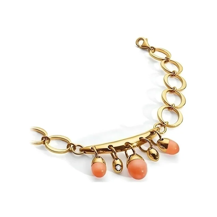 Gold bracelet with smooth coral beads and a sparkling accent, featuring a chain design with linked oval shapes.