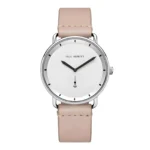 Minimalist silver watch with a white face, black hands, and an anchor symbol, featuring a soft beige leather strap.