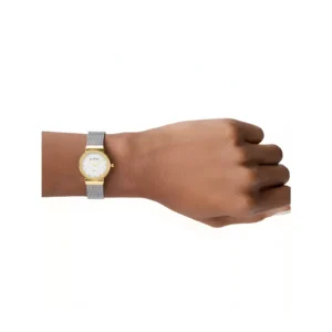A close-up of a wrist wearing a stylish gold and silver mesh wristwatch with a white face and simple, elegant design.