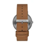 Close-up of a Skagen watch featuring a sleek metal case and a tan leather strap with buckle detail.
