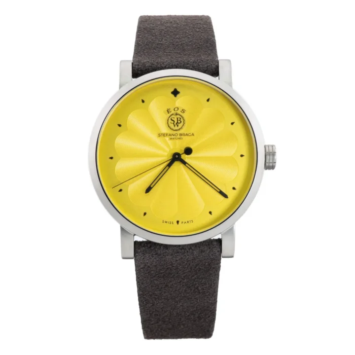 A vibrant yellow watch with a textured dial and black hands, paired with a dark brown suede strap. Designed by Stefano Braga.