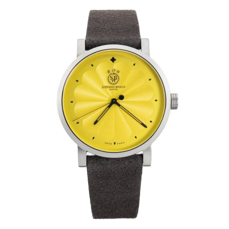 A vibrant yellow watch with a textured dial and black hands, paired with a dark brown suede strap. Designed by Stefano Braga.