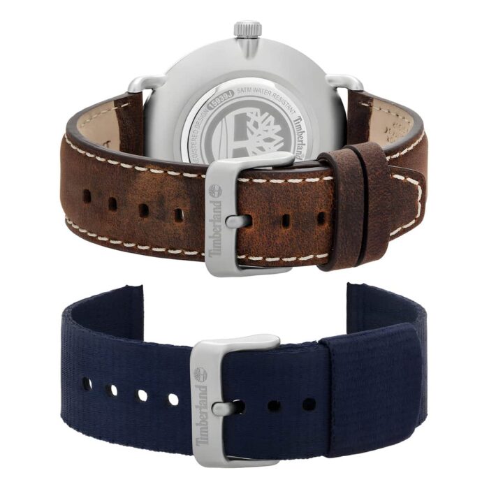 A Timberland watch with a brown leather strap above and a navy fabric strap below, showcasing interchangeable styles.
