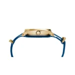Close-up of a gold wristwatch featuring a blue woven strap and a crown for adjusting time, highlighting its elegant design.