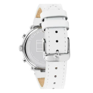 Close-up of a Tommy Hilfiger wristwatch featuring a white leather strap and stainless steel case with silver accents.