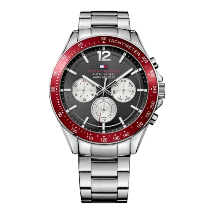 Tommy Hilfiger men's watch with silver stainless steel band, black dial, red tachymeter bezel, and three subdials for timekeeping.