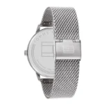 A sleek silver Tommy Hilfiger watch featuring a mesh strap and polished case, showcasing the brand logo on the back.