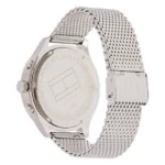 Silver Tommy Hilfiger watch with a mesh band; the back features the brand logo and details about the stainless steel material.