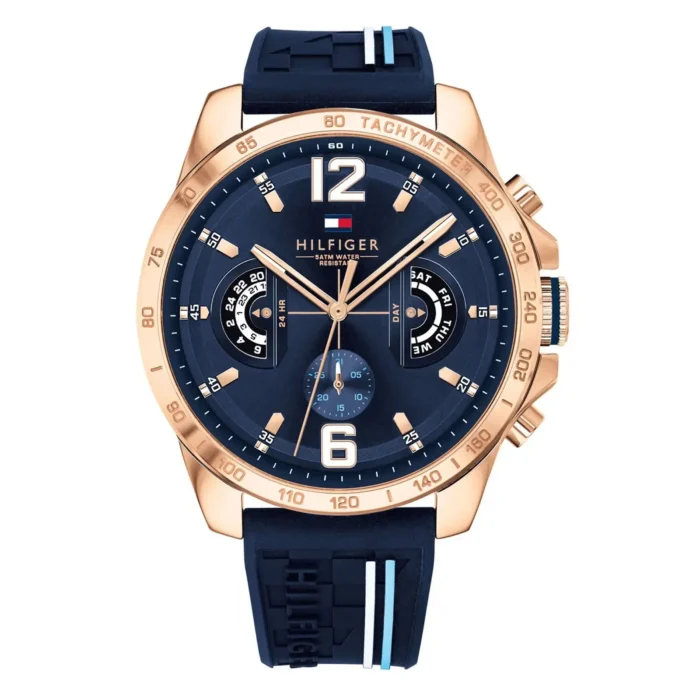 Navy blue Tommy Hilfiger watch with rose gold accents, rubber strap, chronograph function, and day/date displays.