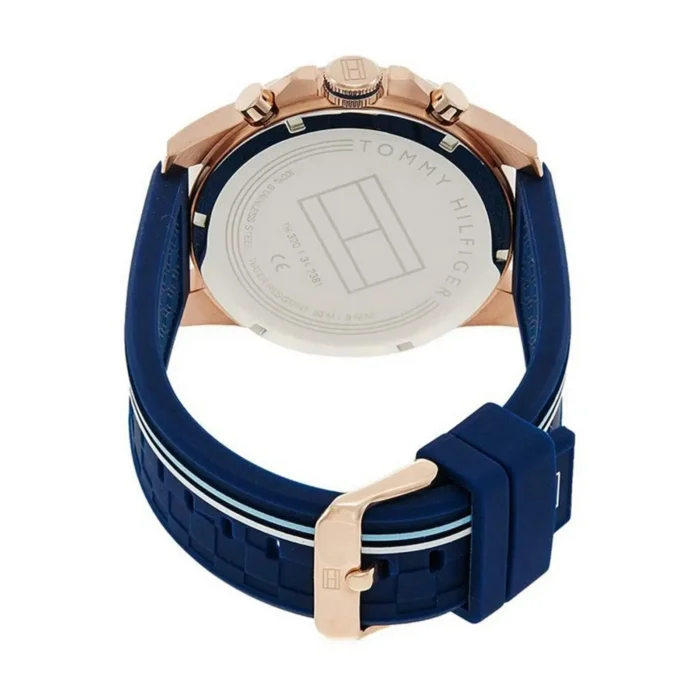 Back view of a Tommy Hilfiger watch featuring a rose gold case and a navy blue silicone strap with white stripes.