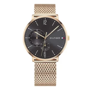 A stylish gold mesh strap watch with a black dial, featuring minimalist hour markers and sub-dials, by Tommy Hilfiger.