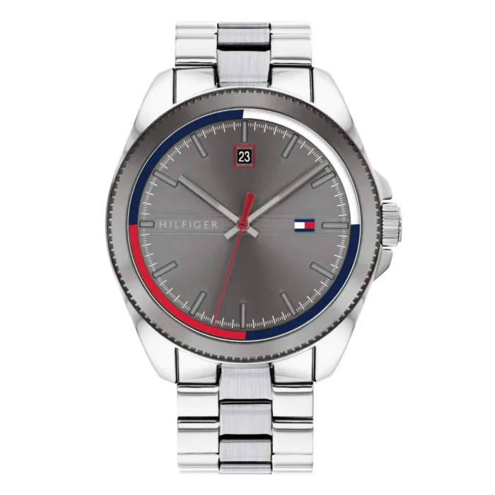 Silver Tom Hilfiger watch with a gray dial, red and blue accents, date display, and a sleek steel bracelet.